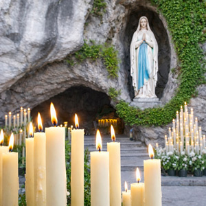 Light a candle at the Lourdes Grotto